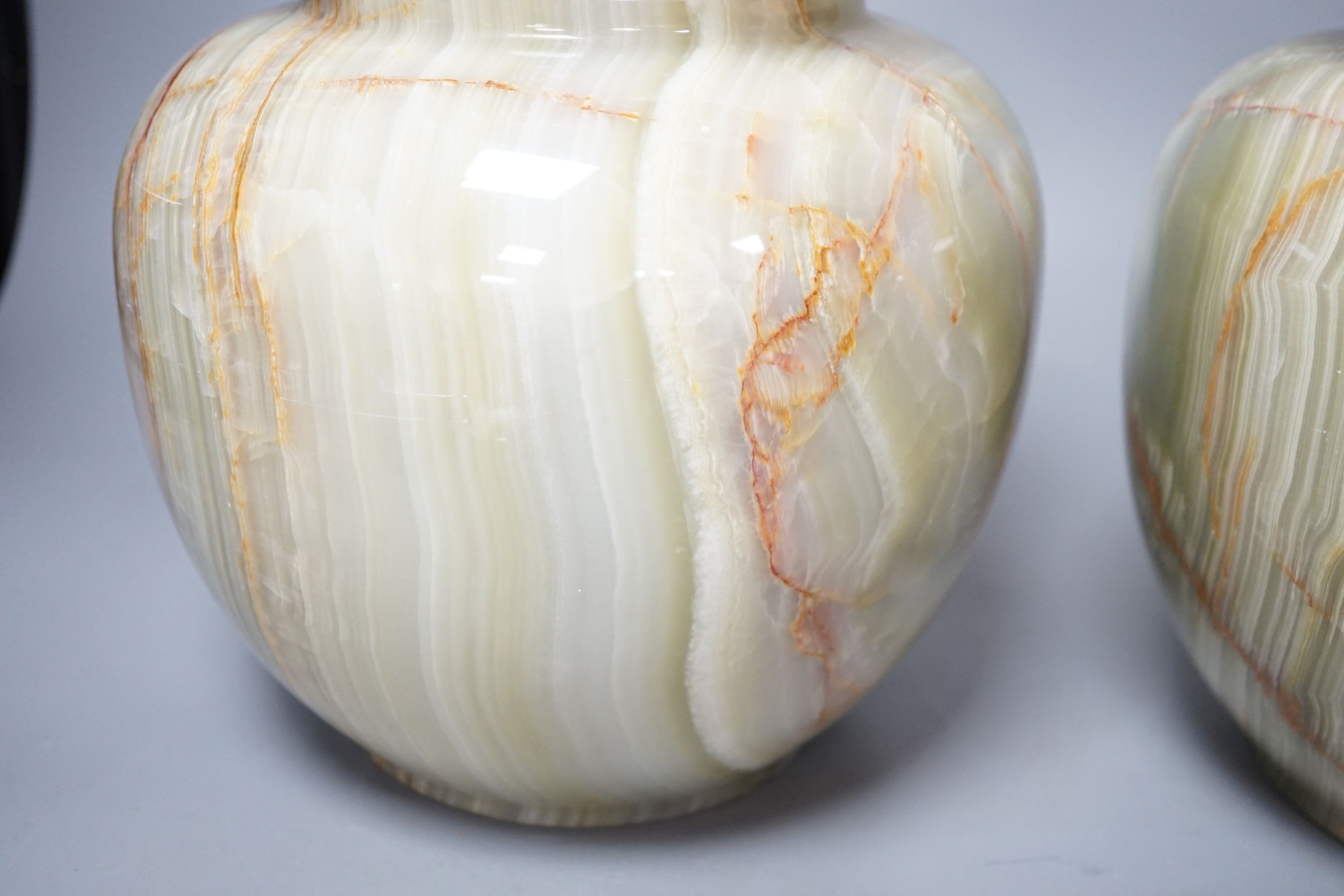 A pair of green onyx vases, 23 cms high.